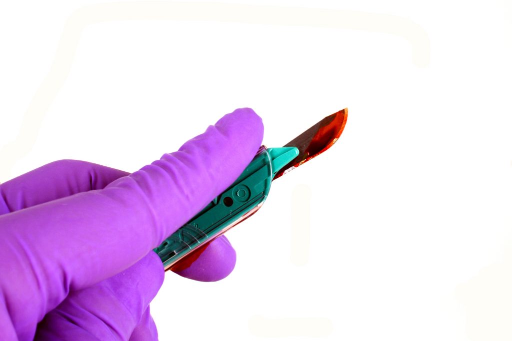 Picture of safety scalpel with blood on it