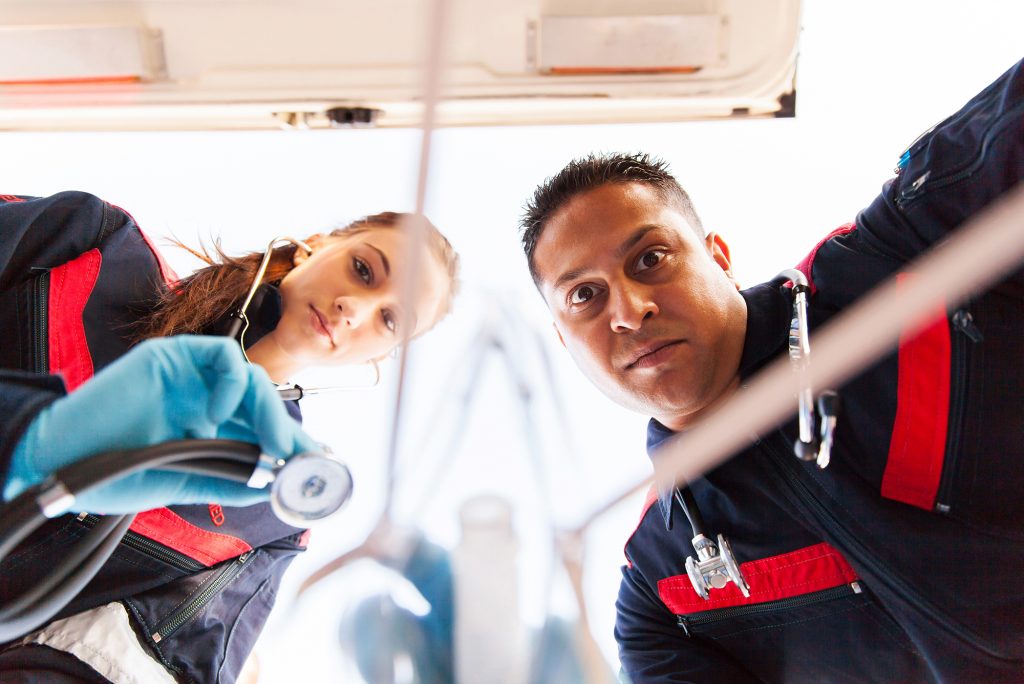 paramedic applying breathing mask