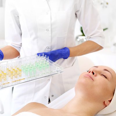 Qlicksmart Cosmetics In An Ampoule.The Beautician Holds Trays With Cosmeti